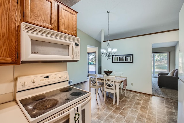 kitchen with white appliances, vaulted ceiling, a chandelier, and hanging light fixtures