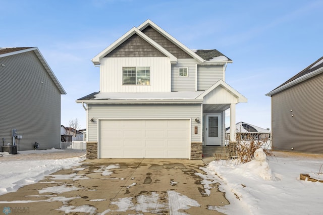 craftsman inspired home featuring central air condition unit and a garage