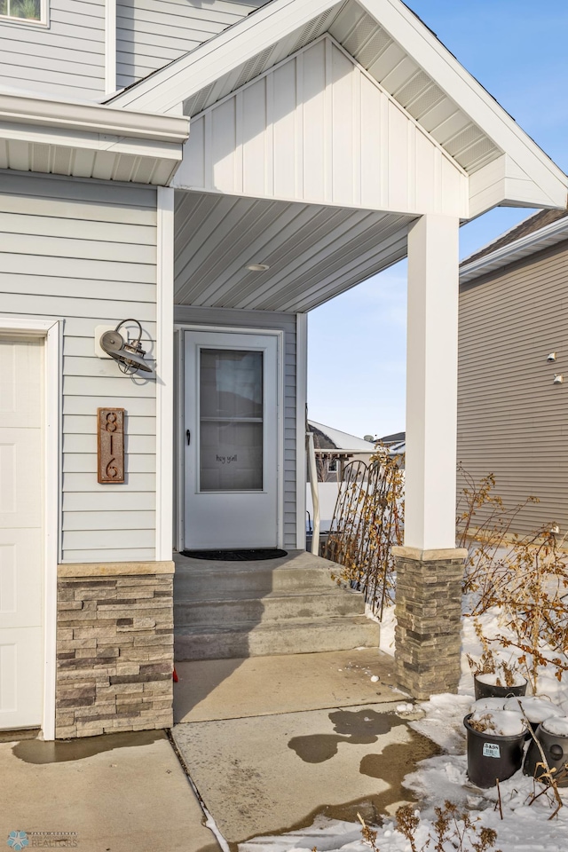 view of snow covered property entrance