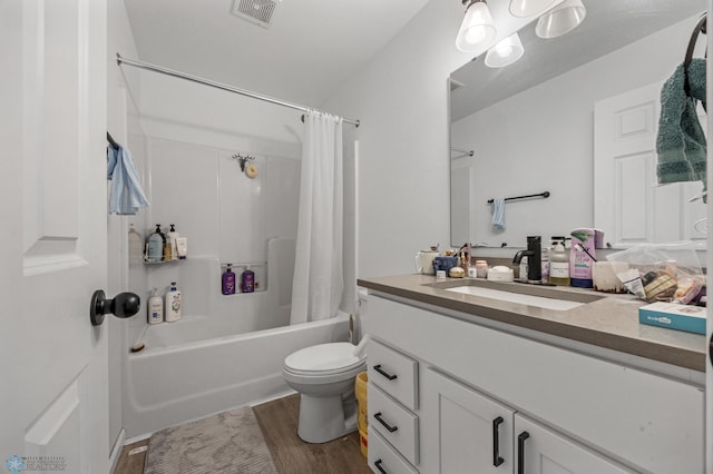 full bathroom featuring toilet, shower / bathtub combination with curtain, wood-type flooring, and vanity