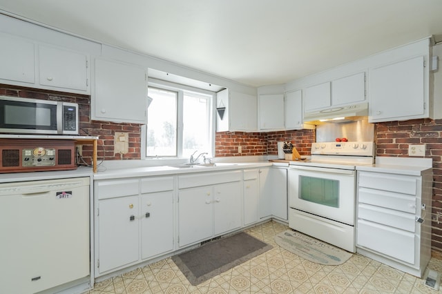 kitchen with sink, white cabinets, and white appliances