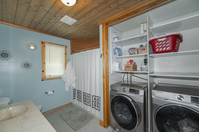 laundry room with washing machine and dryer and wood ceiling