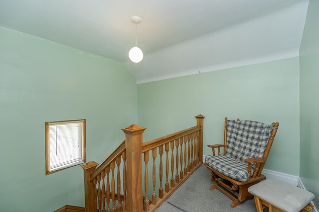 living area featuring lofted ceiling and carpet