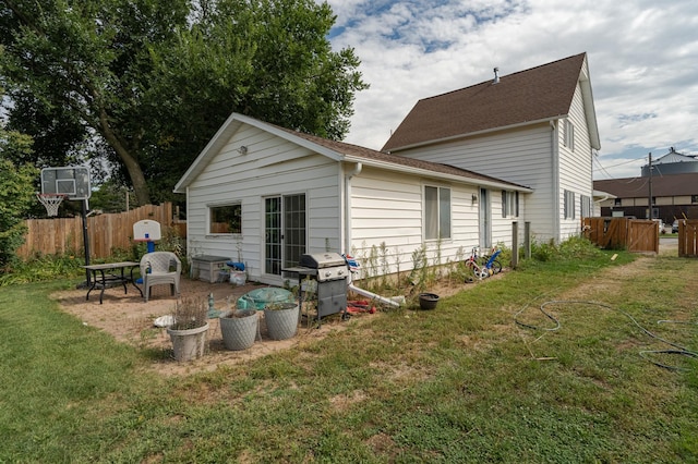 back of house with a lawn