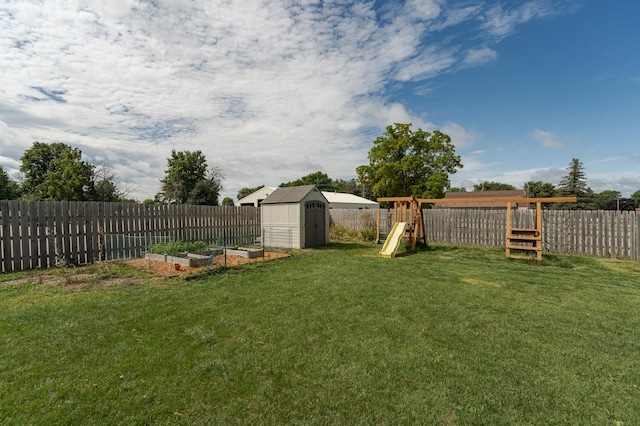 view of yard featuring a playground and a shed