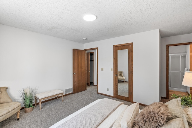 bedroom featuring dark carpet and a textured ceiling