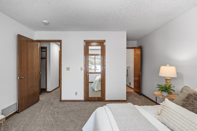 bedroom with a textured ceiling and carpet flooring