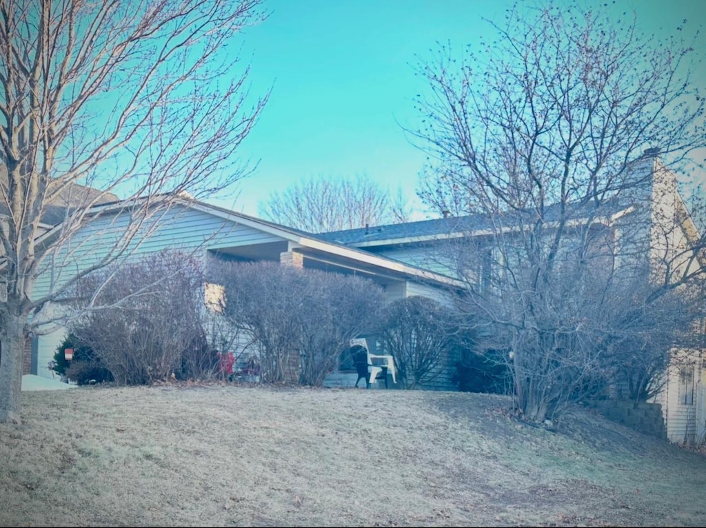 view of side of home with a lawn