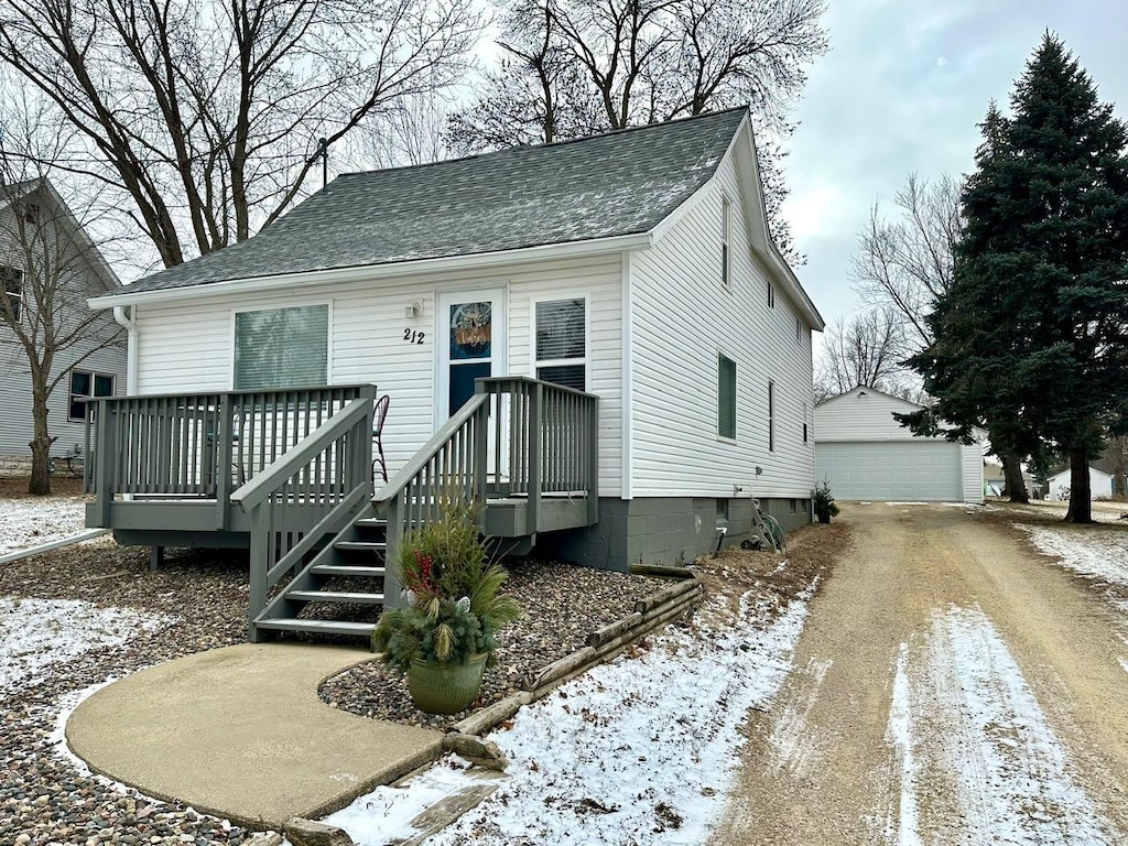 view of front facade with a garage and an outbuilding