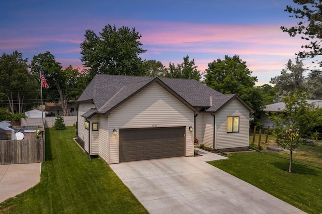 view of front of home with a lawn and a garage