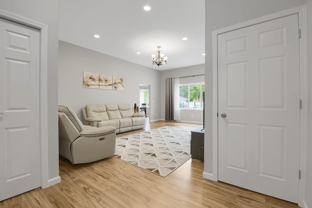 living room with a chandelier and light hardwood / wood-style flooring