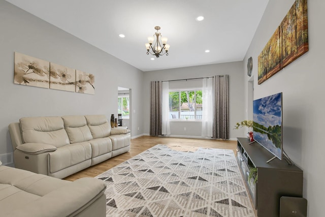 living room featuring wood-type flooring and a chandelier