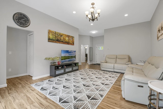 living room featuring light hardwood / wood-style flooring and a notable chandelier