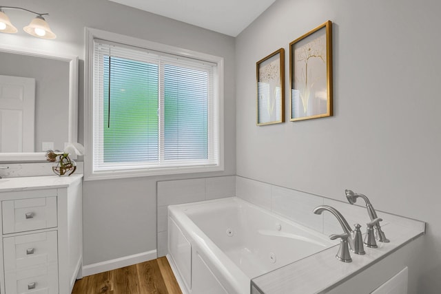 bathroom featuring a bathing tub, hardwood / wood-style floors, and vanity