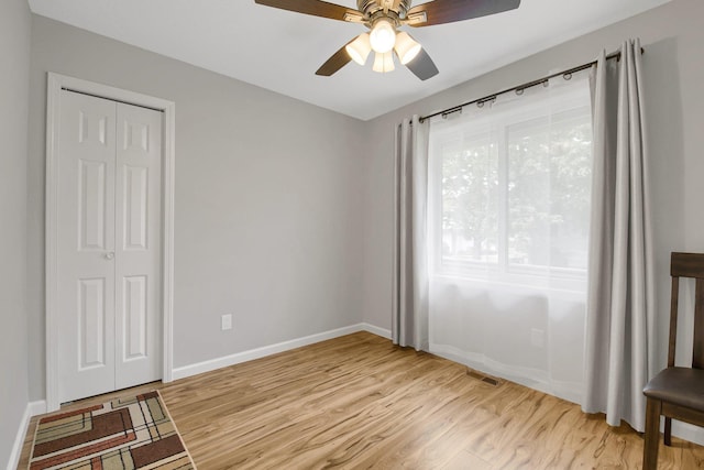 bedroom featuring ceiling fan, a closet, and light hardwood / wood-style floors