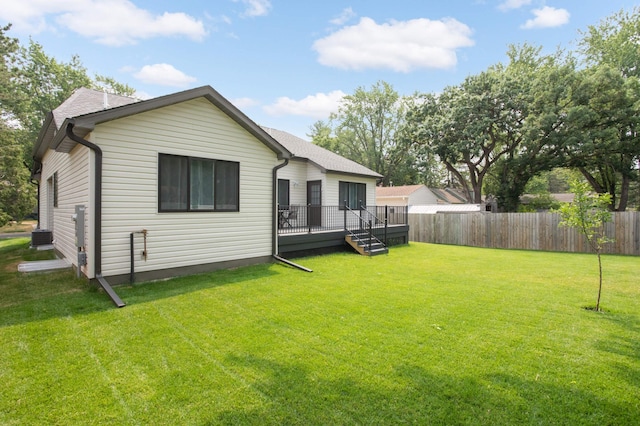 back of house with a wooden deck, cooling unit, and a yard