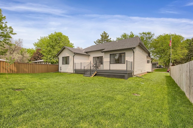 back of house with a lawn and a deck