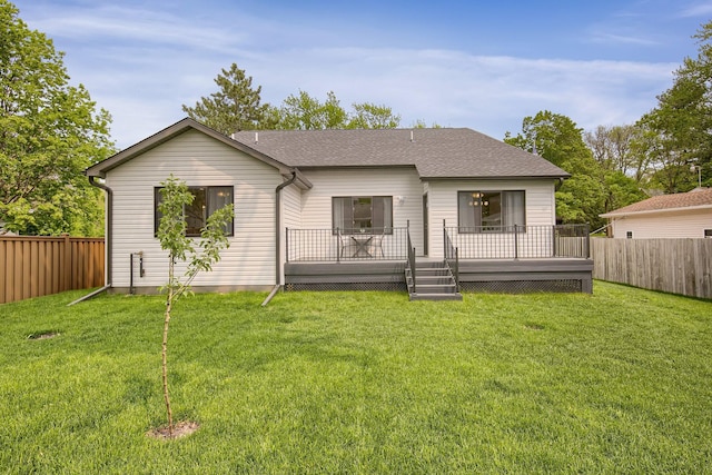 back of house featuring a wooden deck and a lawn