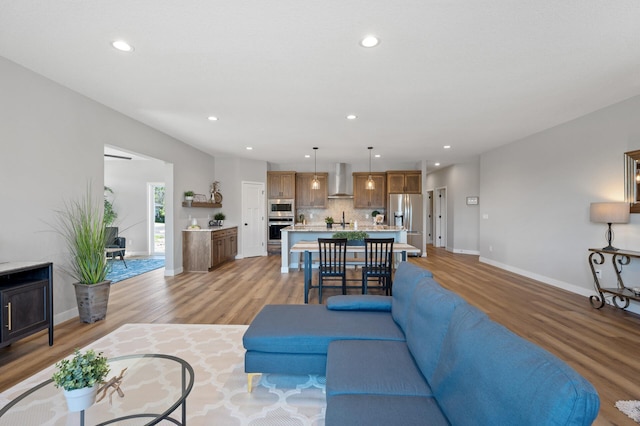 living room with sink and light hardwood / wood-style flooring