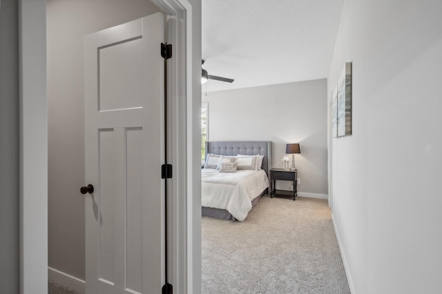 bedroom with light carpet and ceiling fan