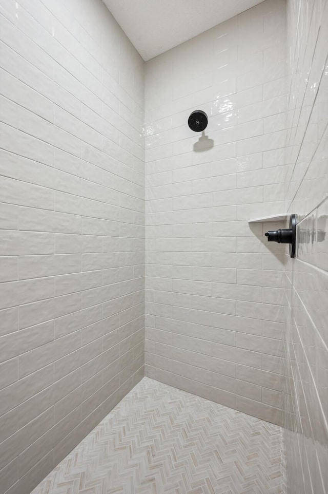 bathroom with tiled shower