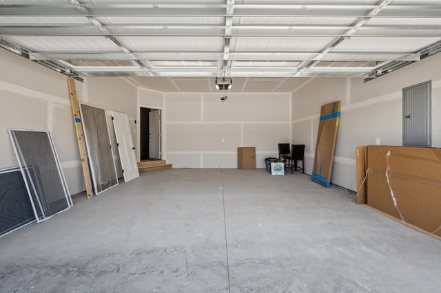 garage with a garage door opener and electric panel