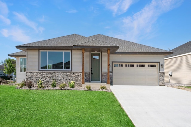 prairie-style house featuring a garage and a front yard