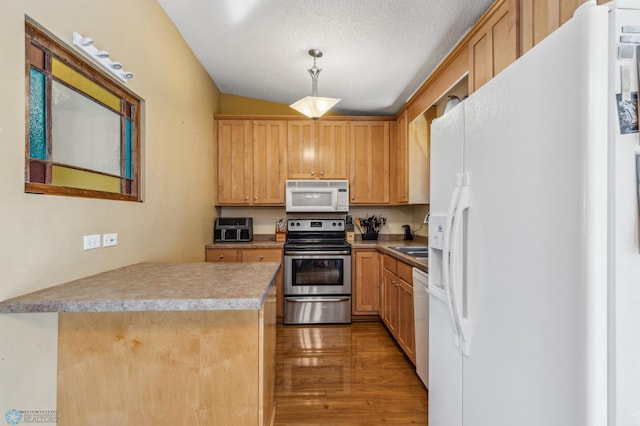 kitchen featuring white appliances, a textured ceiling, pendant lighting, dark hardwood / wood-style floors, and light brown cabinets