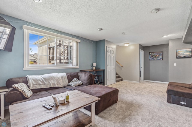 carpeted living room featuring a textured ceiling