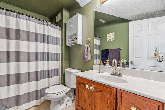 bathroom featuring toilet, a textured ceiling, and vanity