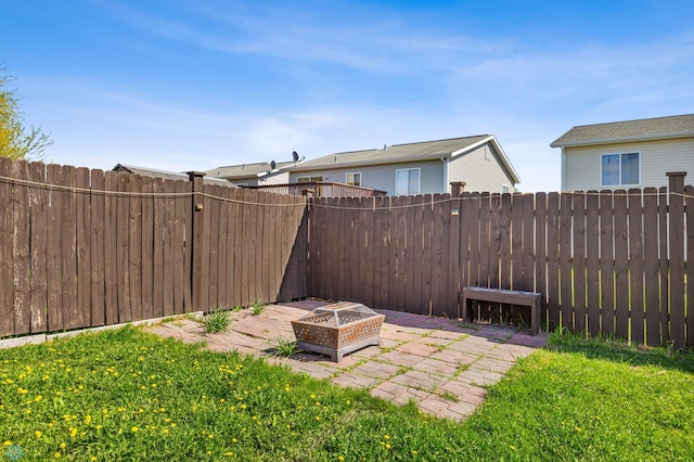 view of yard featuring a patio and an outdoor fire pit