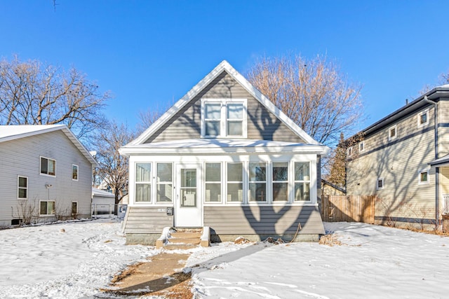 view of snow covered rear of property