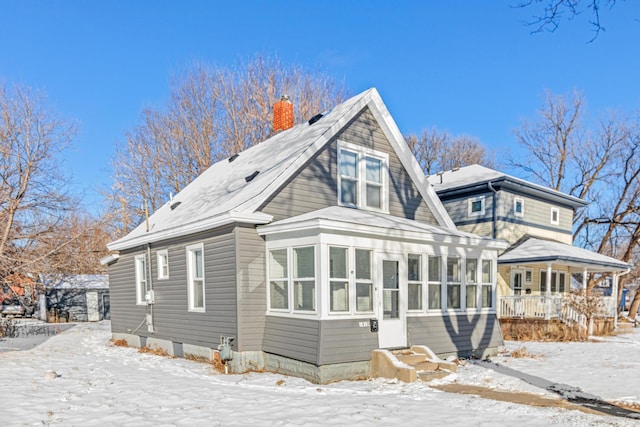 view of snow covered rear of property