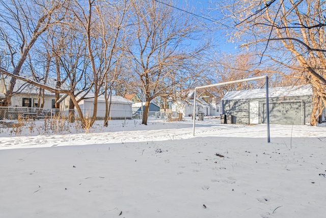 yard covered in snow with a garage