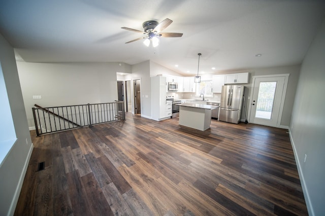 kitchen with a center island, sink, white cabinetry, hanging light fixtures, and appliances with stainless steel finishes