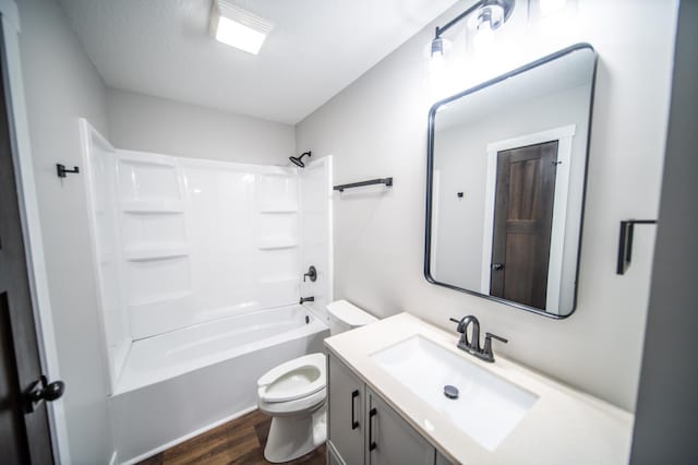 full bathroom with toilet, wood-type flooring, a textured ceiling, tub / shower combination, and vanity