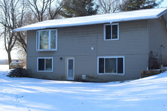 view of snow covered rear of property