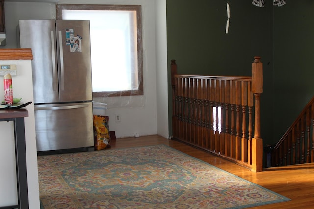 kitchen with hardwood / wood-style flooring and stainless steel fridge