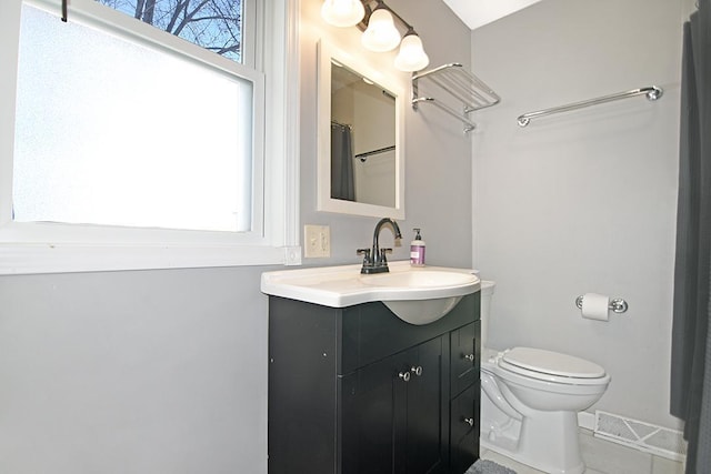 bathroom featuring toilet and vanity