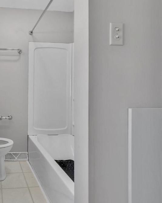 bathroom featuring tile patterned flooring and toilet