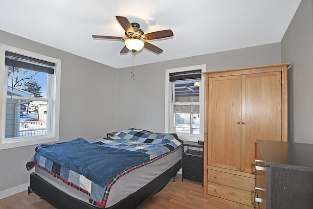 bedroom with ceiling fan and light hardwood / wood-style floors