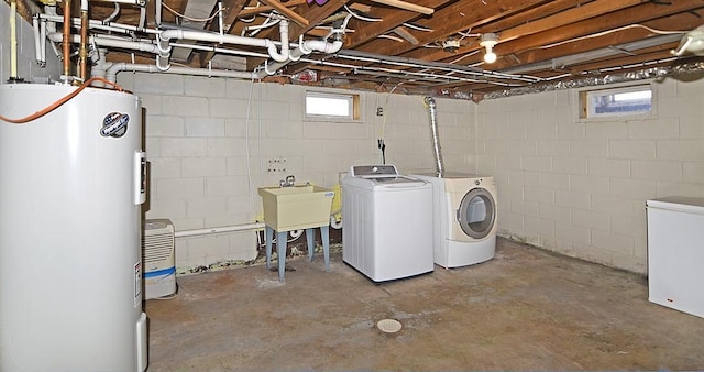 laundry room with sink, water heater, a healthy amount of sunlight, and independent washer and dryer