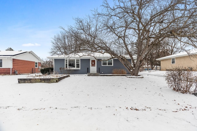 view of snow covered rear of property