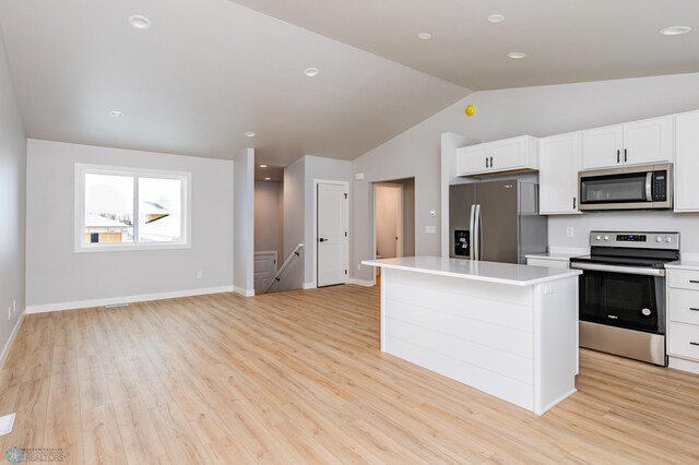 kitchen featuring appliances with stainless steel finishes, white cabinets, light hardwood / wood-style flooring, and a center island