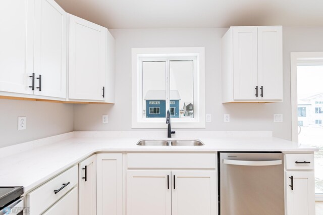 kitchen with sink, white cabinets, and appliances with stainless steel finishes