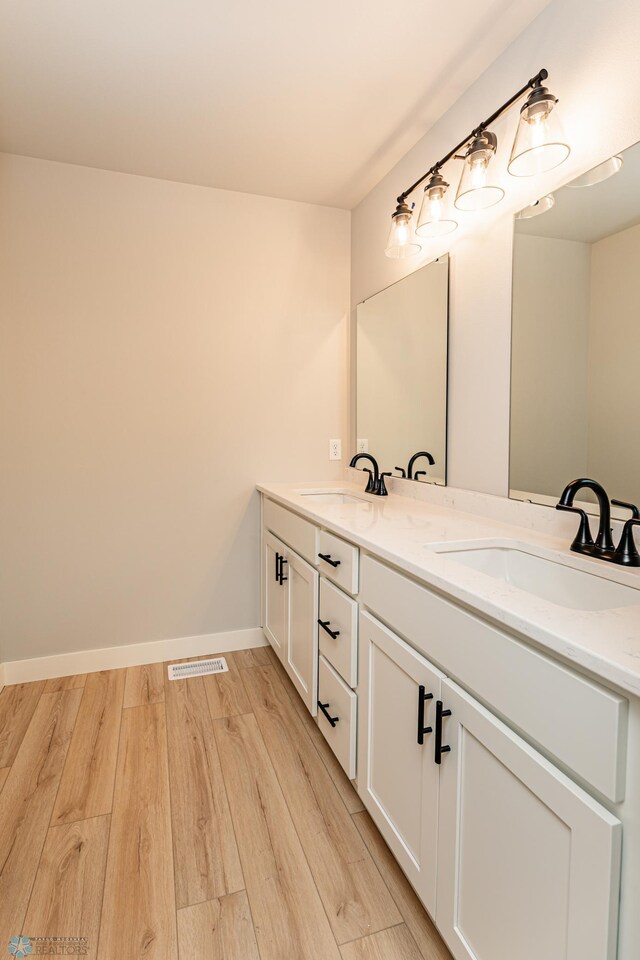 bathroom featuring hardwood / wood-style flooring and vanity