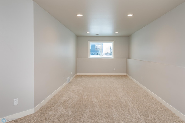 unfurnished room with light colored carpet