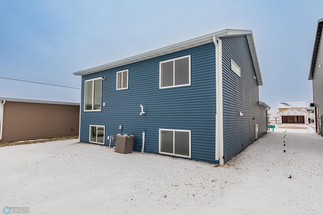 rear view of property with central AC