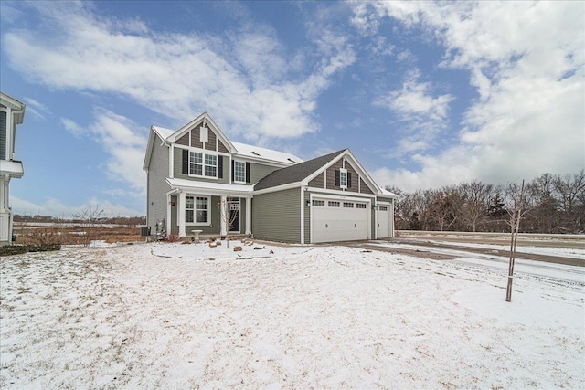 view of front of property with central AC and a garage