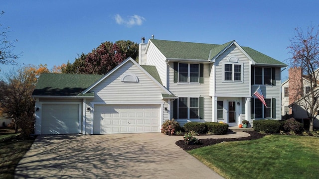 view of front of home with a front yard and a garage